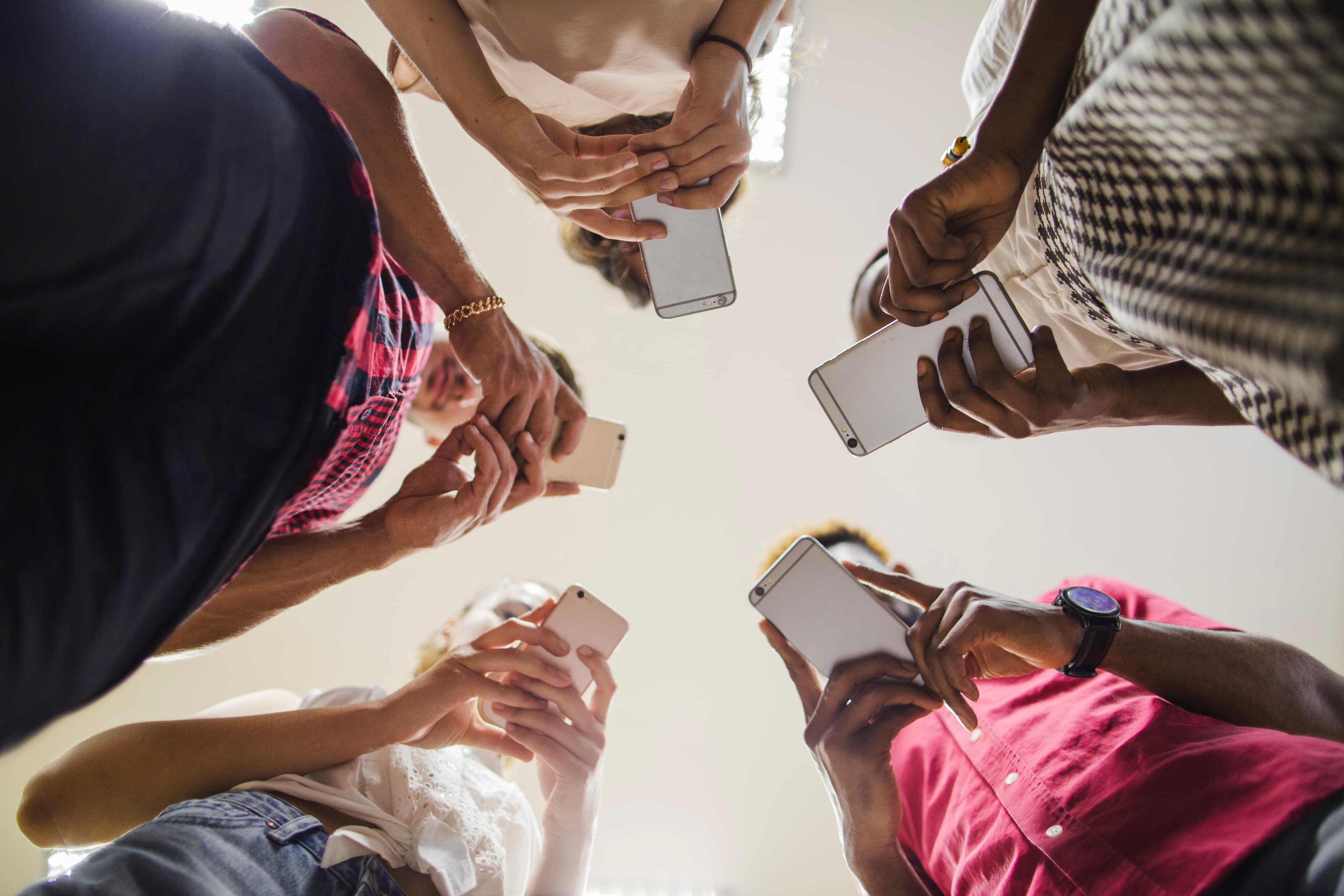 Group of attendees gathered in a circle holding their phones